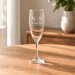 Custom champagne flute for an anniversary toast with clear glass engraving
