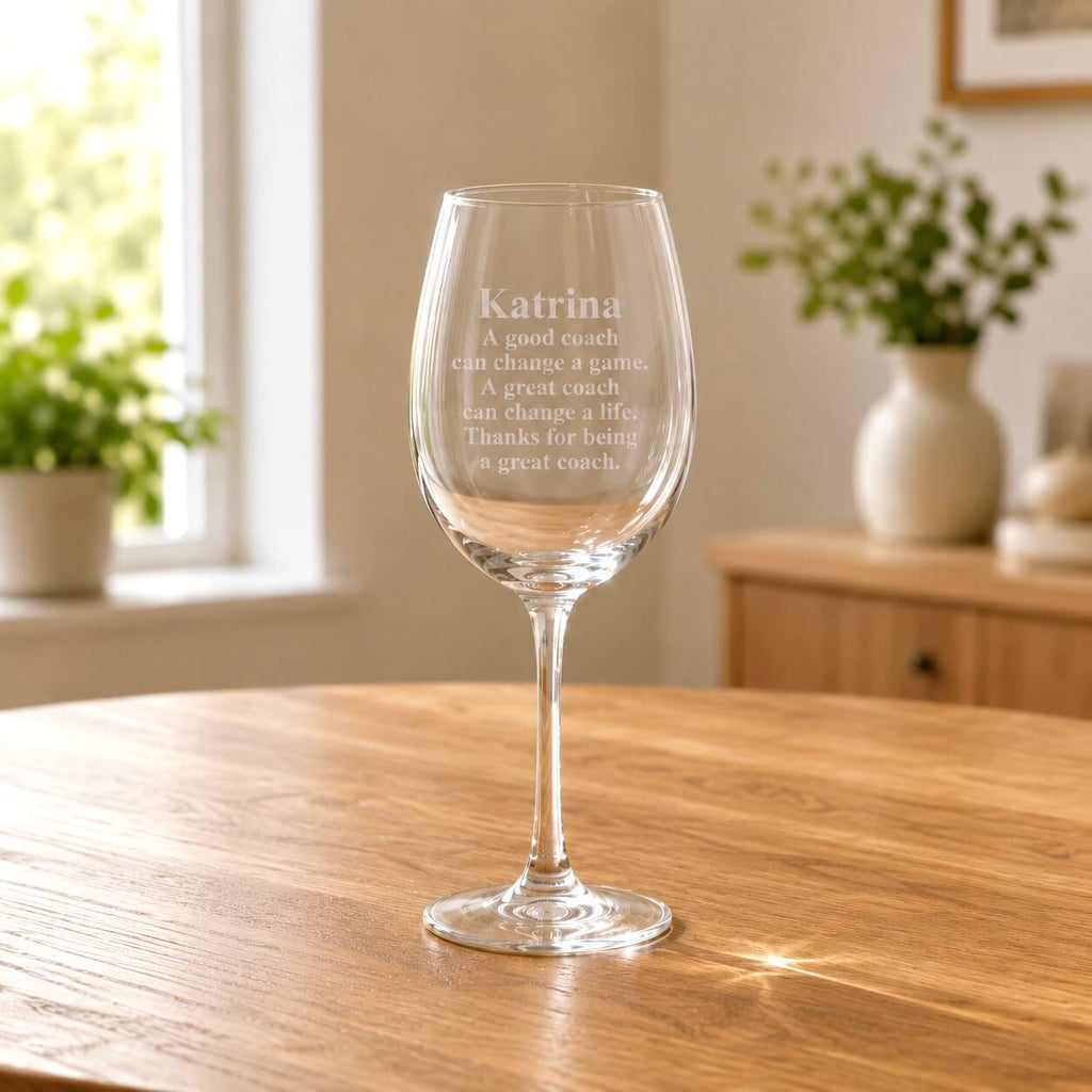 Custom coach wine glass with etched message and soft natural window light