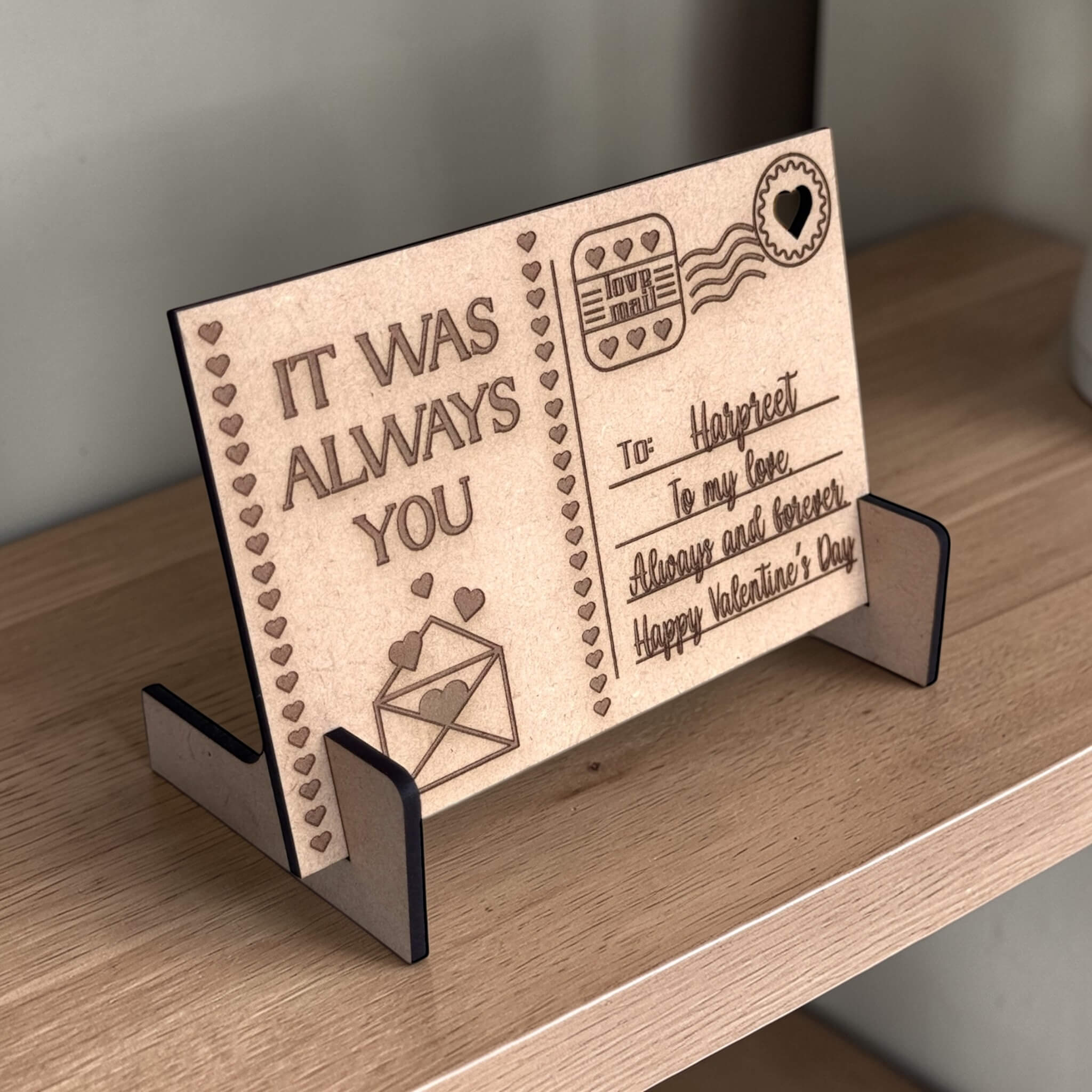 Custom engraved MDF wooden postcard on stand on wooden shelf, personalised Valentine's Day keepsake gift for her