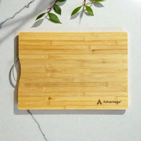 Custom engraved bamboo chopping board with Advantage logo and stainless steel handle on marble surface, branded corporate gift