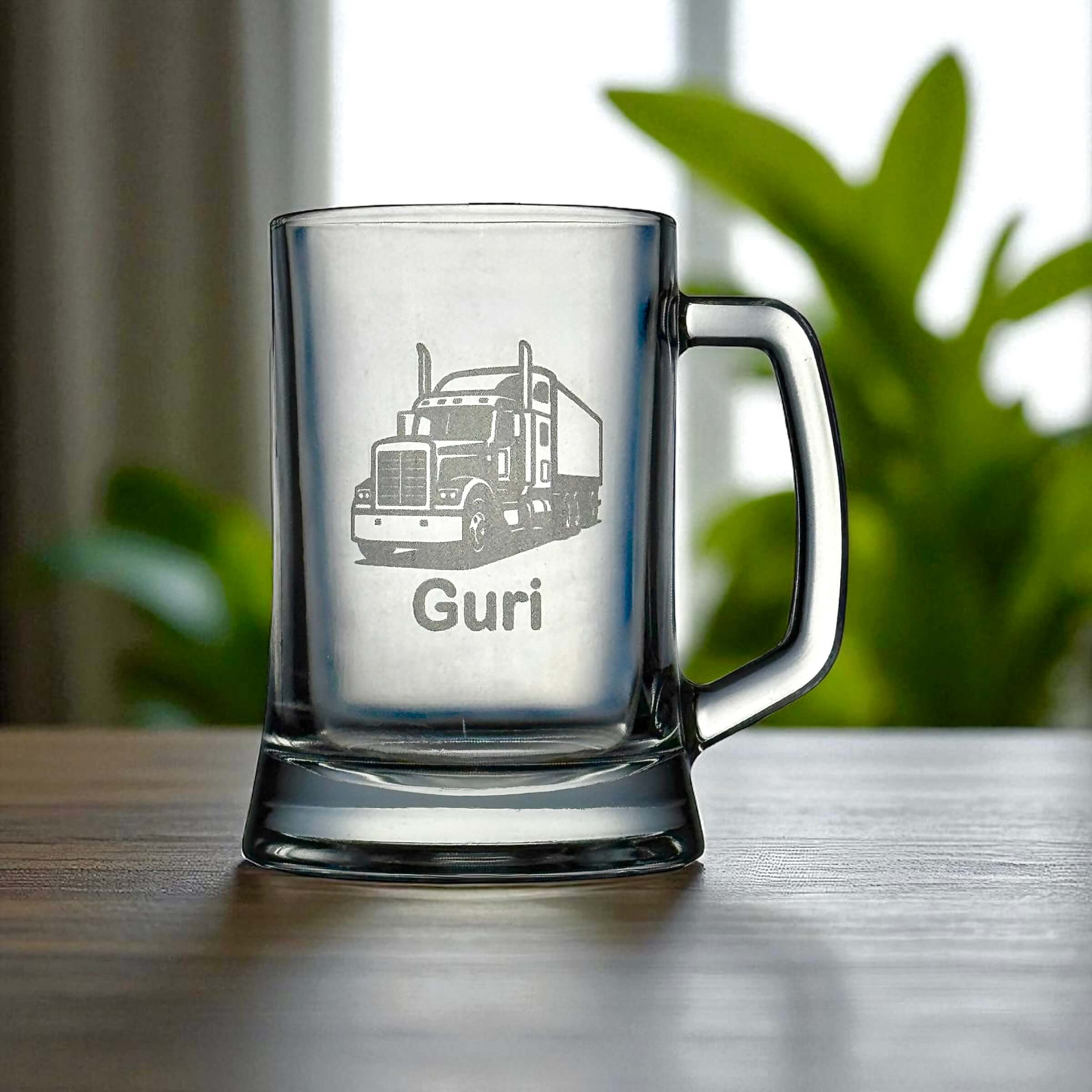 Custom engraved beer stein with truck design and personalised name, displayed on a wooden table.