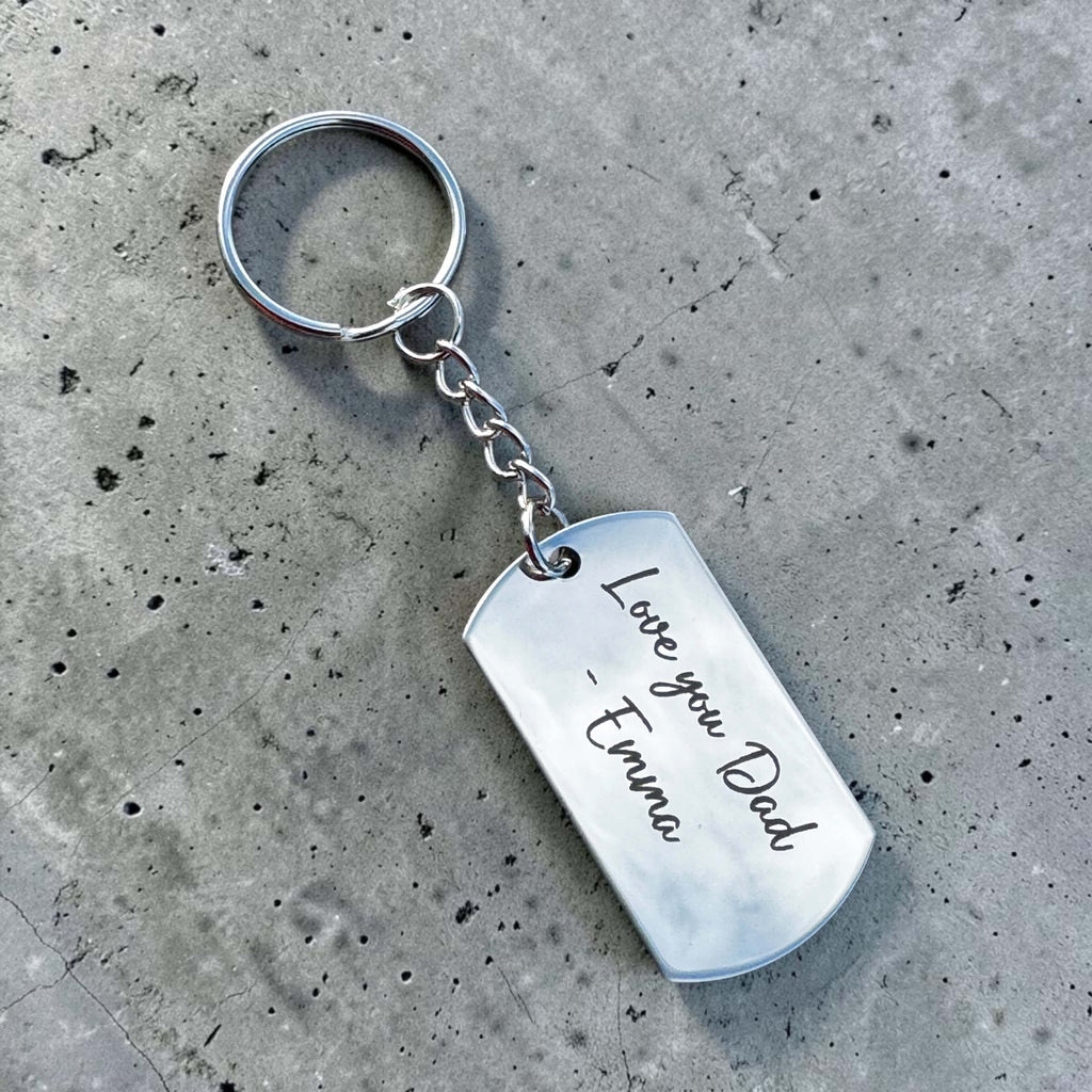 Custom keychain for Dad with dark engraved handwriting-style message on metal