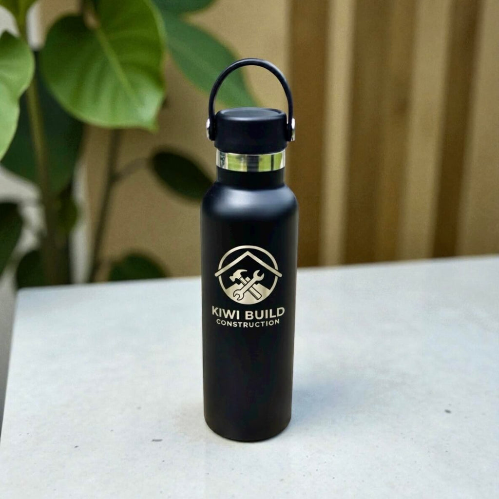 Custom logo water bottle displayed on desk setup for corporate gifting.