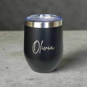 Custom name insulated black coffee cup engraved with Olivia on grey surface