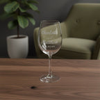 Custom wedding wine glass with engraved couple names displayed in modern lounge