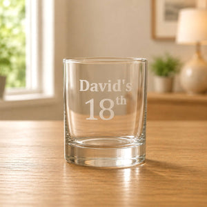 Engraved 18th birthday shot glass in warm light with soft home background