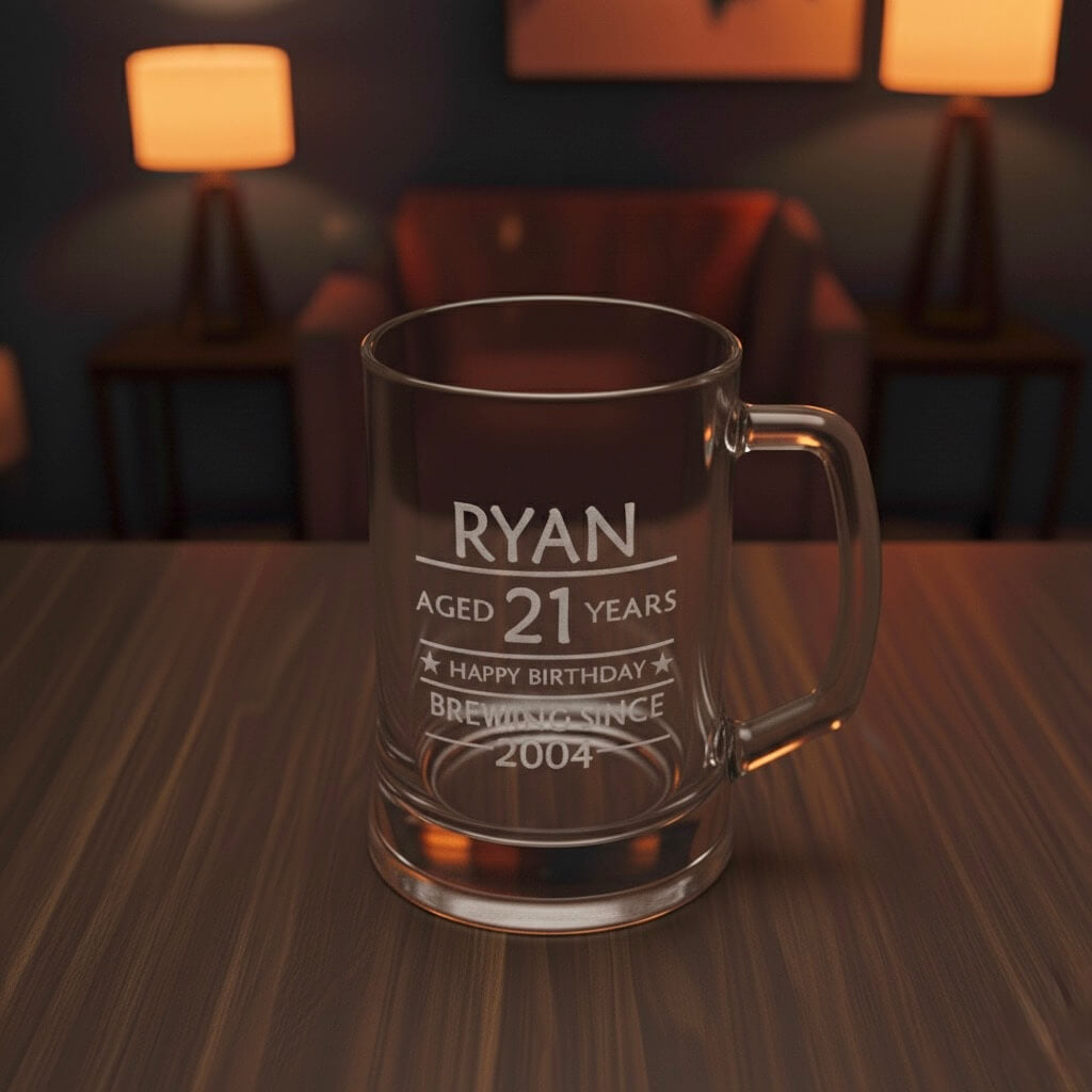 Engraved 21st birthday beer mug with name Ryan and message “Brewing Since 2004” on table with soft lighting
