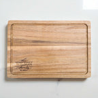 Engraved acacia chopping board featuring The Wilson Family design, perfect personalised gift for housewarming, wedding, or anniversary.