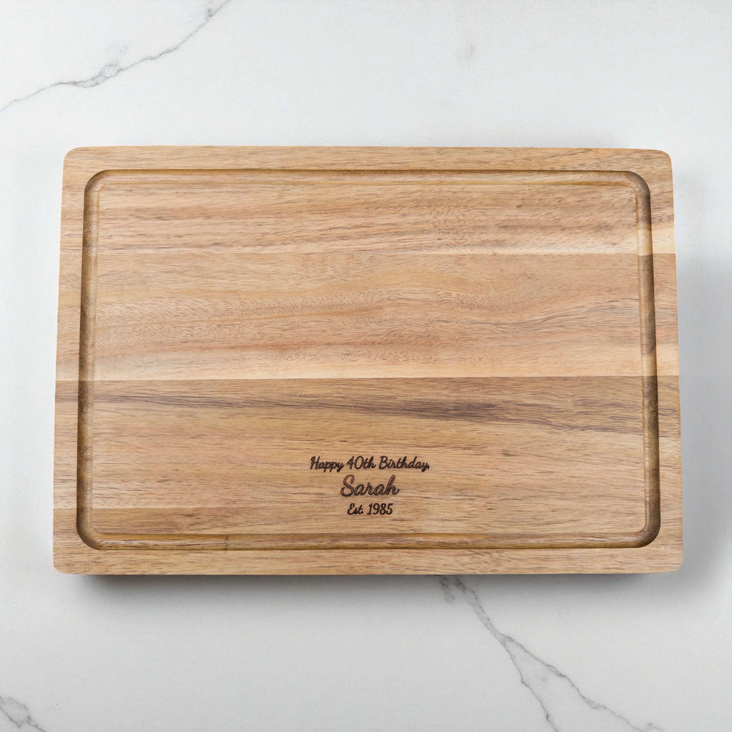 Engraved acacia wood chopping board featuring birthday message and name, personalised kitchen gift idea for 40th birthday celebrations.