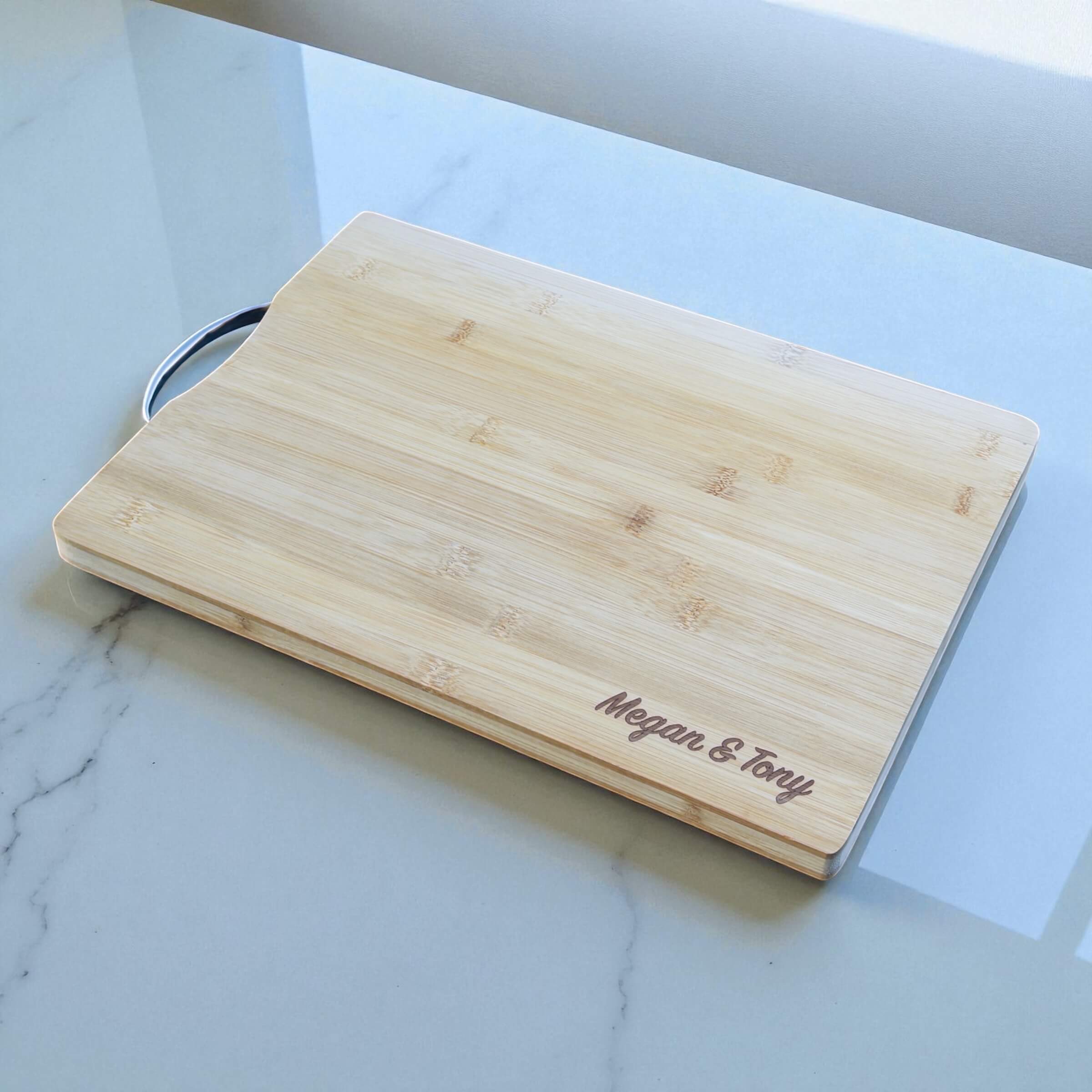 Engraved bamboo chopping board displayed in a modern NZ kitchen as a personalised gift for couples