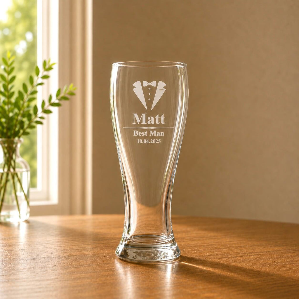 Engraved beer glass with name and tuxedo design displayed on a wooden table