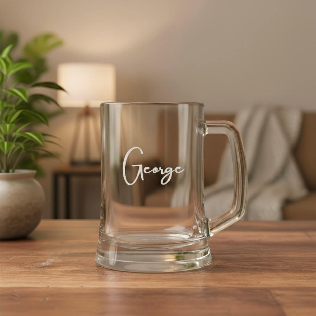 Engraved beer handle featuring the name George in elegant script font, displayed beside potted plant and lamp