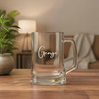 Engraved beer handle featuring the name George in elegant script font, displayed beside potted plant and lamp