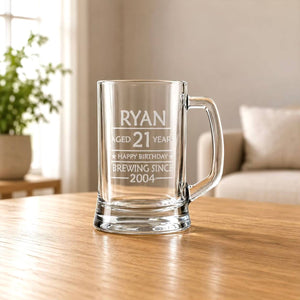 Engraved beer mug for 21st birthday with Ryan name, clear handle and warm home background