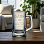 Engraved birthday beer mug with the name Gareth and 'Brewing Since 1995' design, set on a wooden table in a relaxed living room with natural light and indoor plants