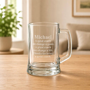 Engraved coach beer glass with name and quote on a wooden table