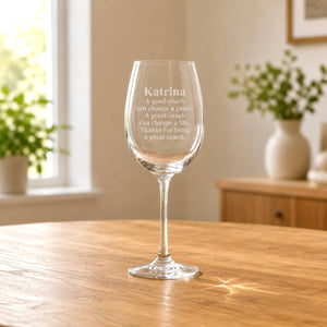 Engraved coach gift wine glass with name and quote in warm home setting