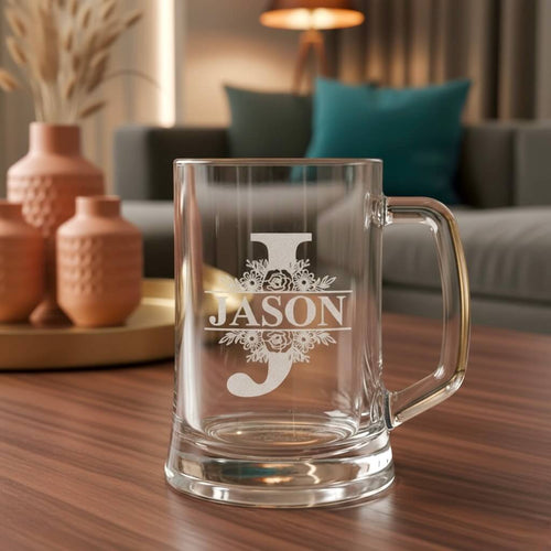 Engraved glass beer handle featuring floral J monogram and Jason name design, set against soft-lit home decor background