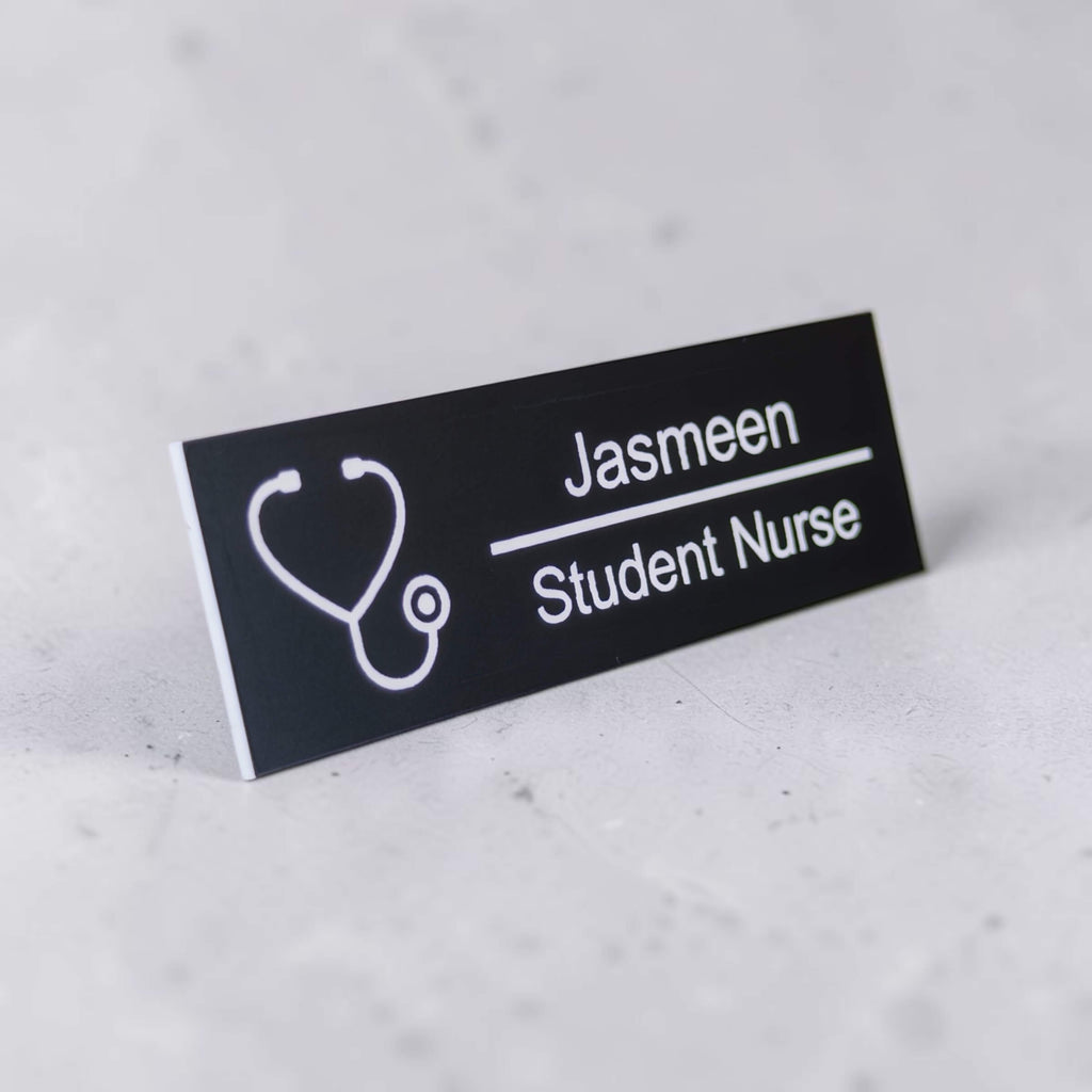 Engraved healthcare name badge lying at an angle with clear name and role