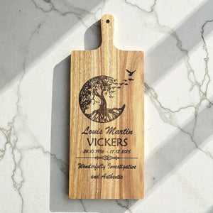 Engraved memorial wooden board with tree of life design, name, dates, and tribute message