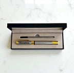 Engraved metal pen presented in black gift box with refill insert, ready for gifting.