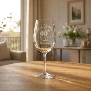 Engraved personalised 40th birthday wine glass gift for her, featuring custom name and message, photographed in a warm modern living room
