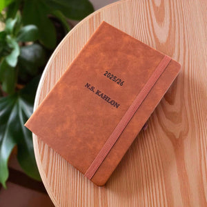 Engraved planner with name on tan PU leather cover and elastic band closure