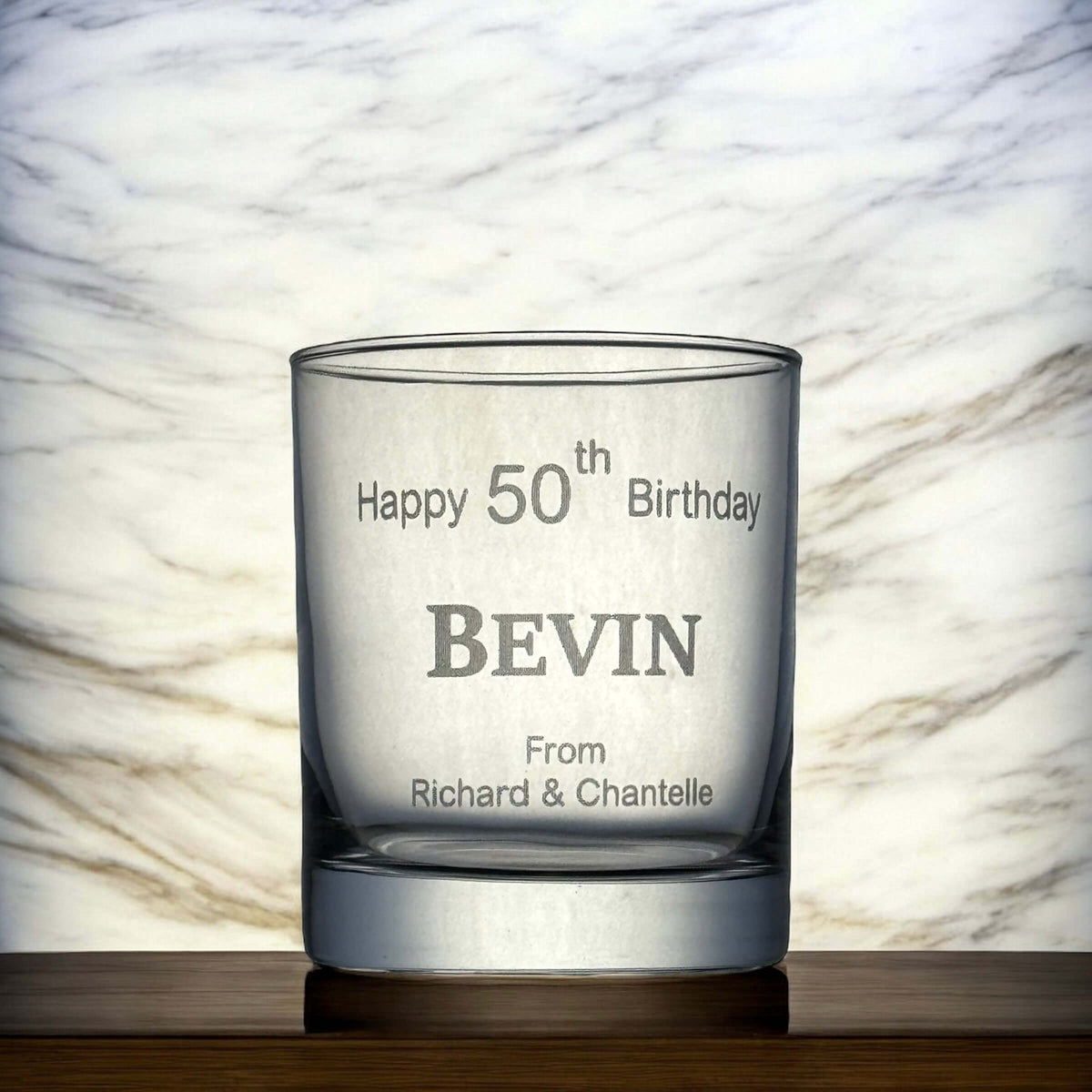 Engraved scotch glass displaying a milestone birthday design, perfect for gifting.