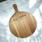 Engraved wooden round serve board with names and dates