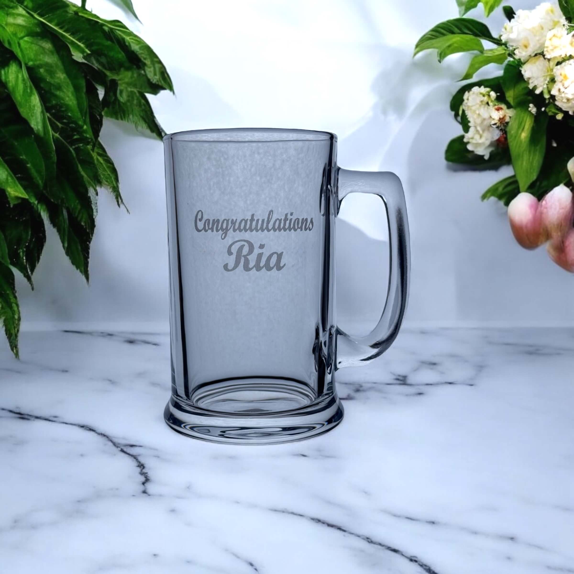 Graduation beer glass being used to toast academic achievement