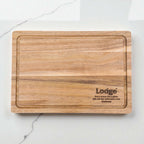 Laser engraved acacia serving board showing Lodge logo and personalised text, high-quality wooden gift for business promotions and staff appreciation.