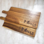 Pair of business-branded serving boards showcasing smooth grain and custom etching