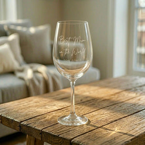 Personalised "Best Mum in the World" wine glass on timber table, custom engraved Mother's Day gift