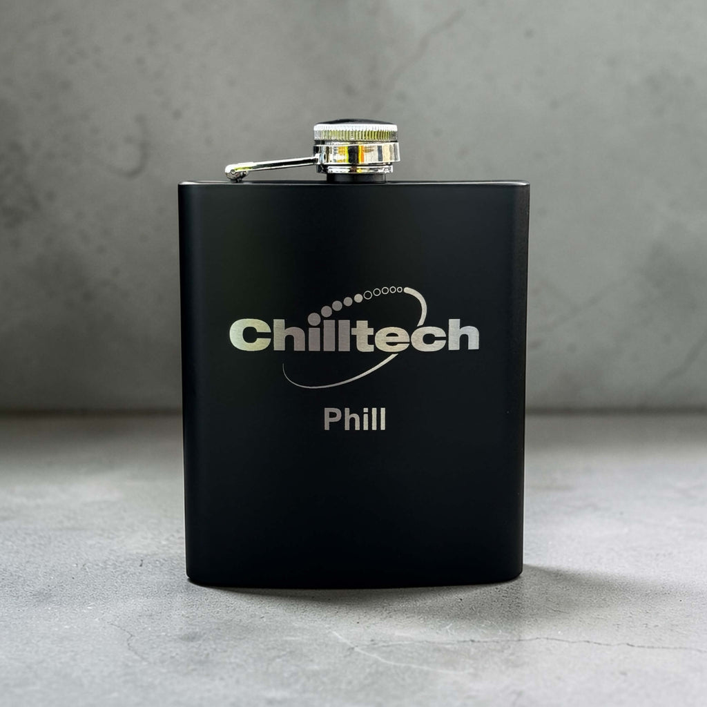 Personalised Black flask with 'Chilltech' branding on a gray surface