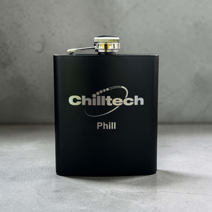 Personalised Black flask with 'Chilltech' branding on a gray surface