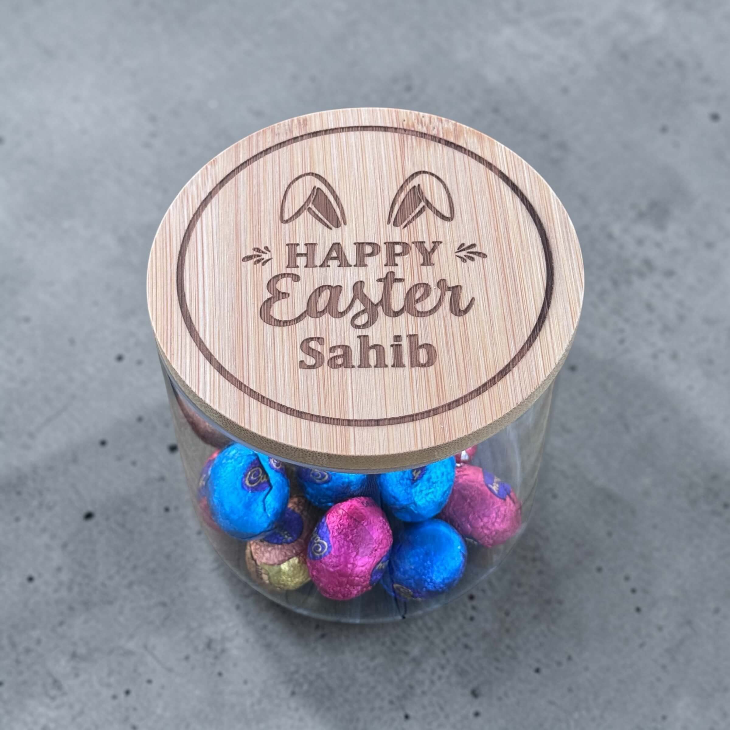 Personalised Easter glass jar with laser engraved bamboo lid, filled with foil wrapped chocolate eggs, custom name Easter gift