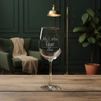 Personalised Mr & Mrs engraved wine glass with couple’s name and wedding date on wooden table.