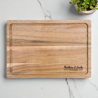 Personalised acacia chopping board engraved with couple names and wedding date, timeless wedding keepsake or anniversary present.
