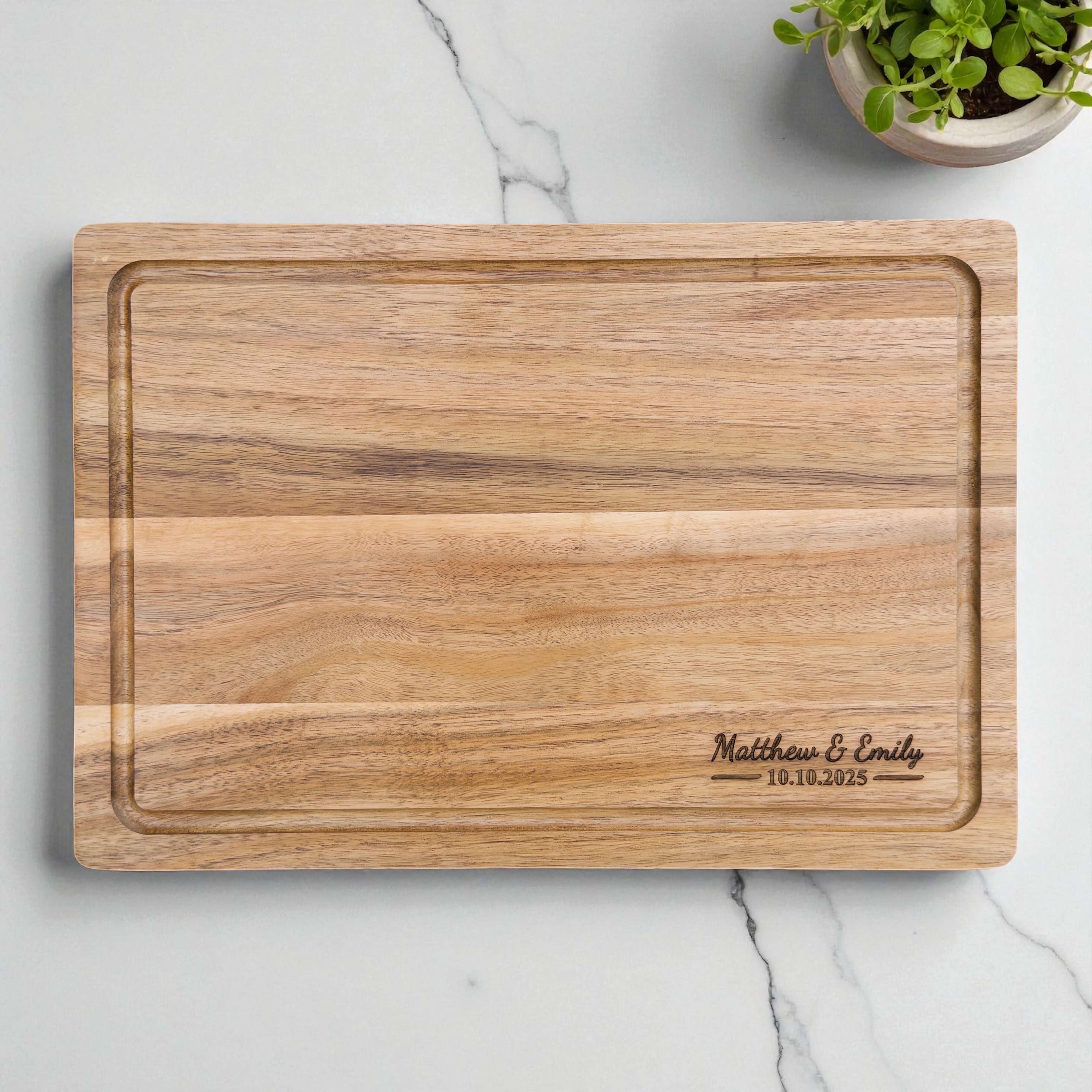 Personalised acacia chopping board engraved with couple names and wedding date, timeless wedding keepsake or anniversary present.
