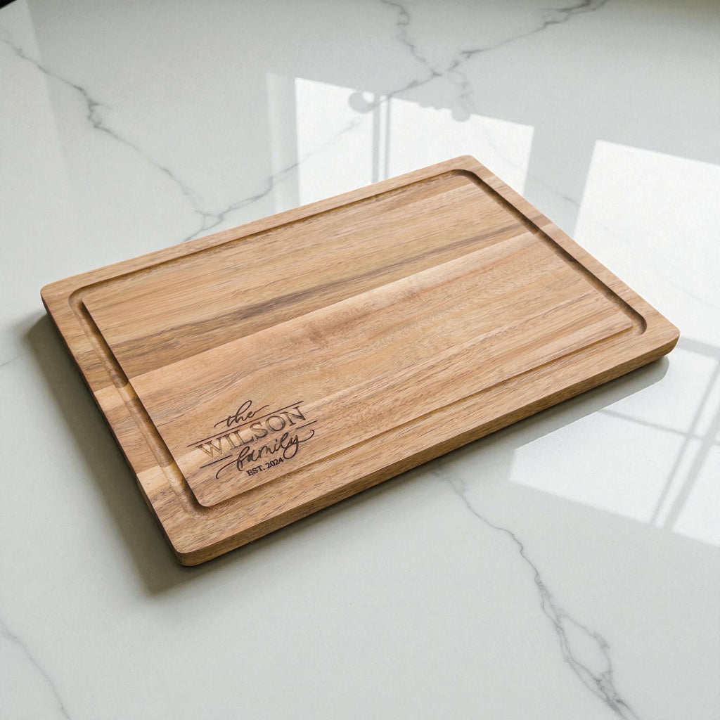 Personalised acacia wood chopping board engraved with family name and Est year, unique housewarming or new home gift idea.