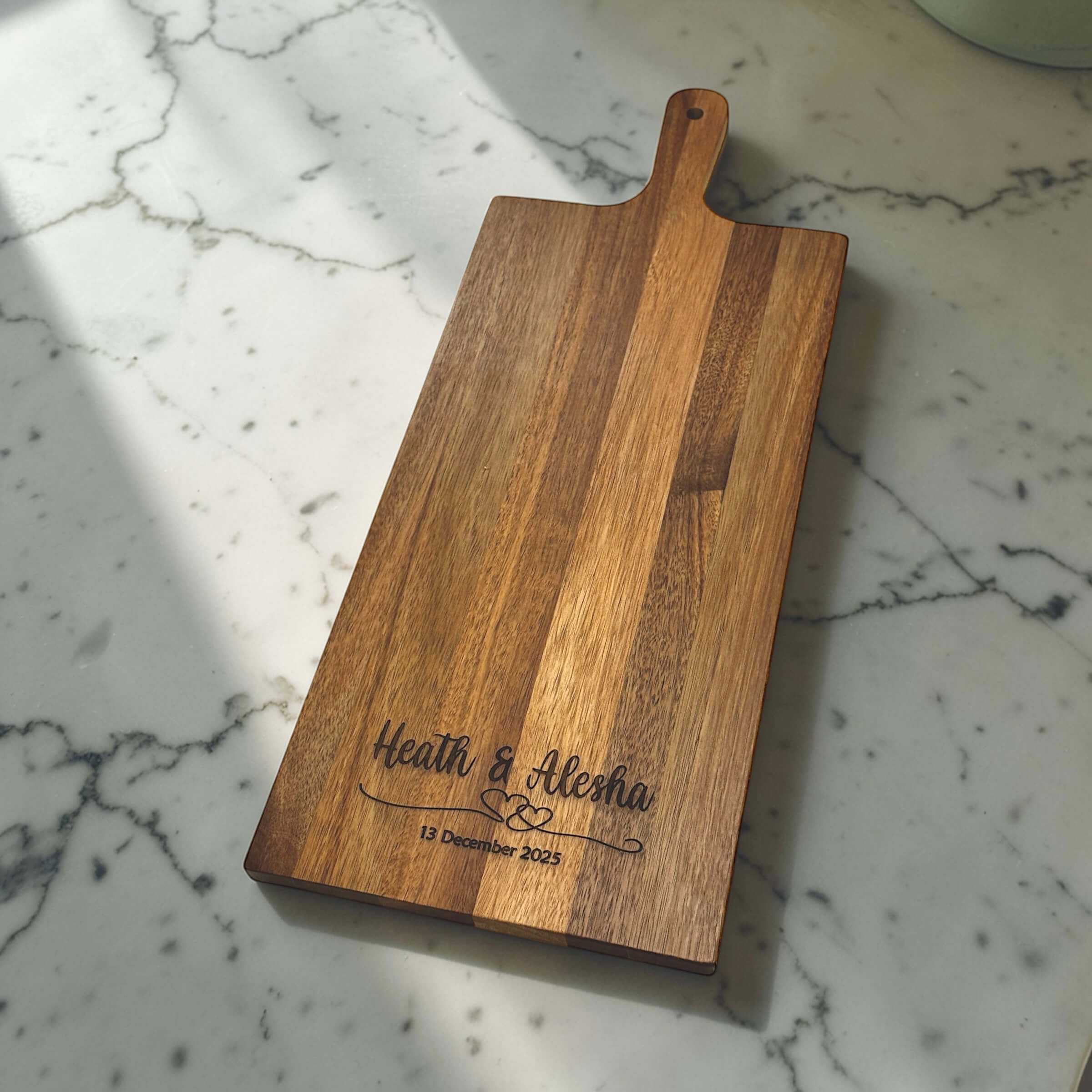 Personalised acacia wood rectangular serving board engraved with couple names Heath and Alesha and wedding date, unique wedding gift idea