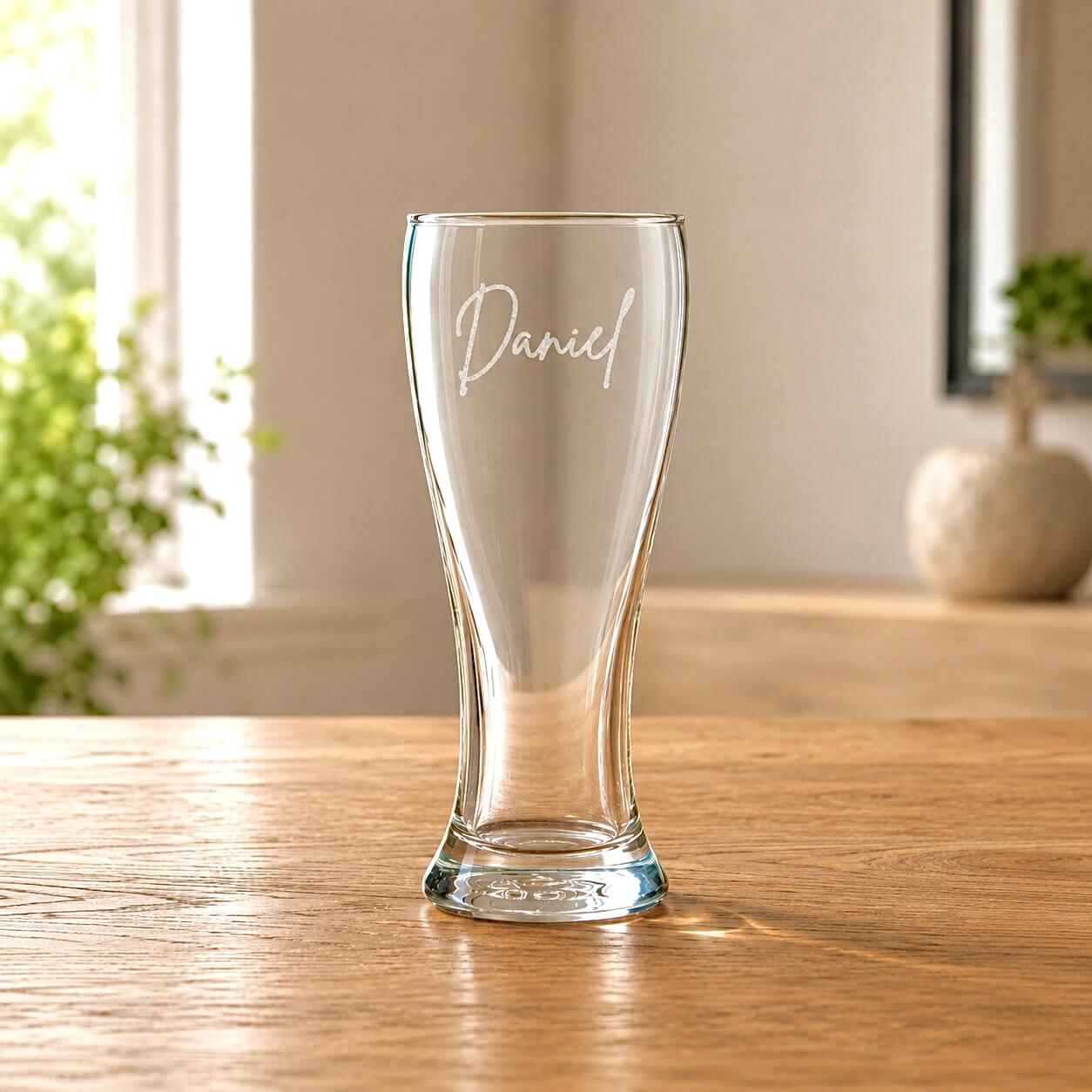Personalised beer glass with frosted name engraving in a warm home setting