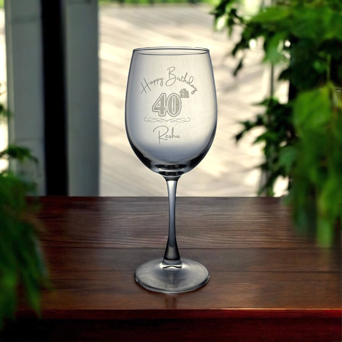 Personalised birthday wine glass with “Happy Birthday 40th Reshu” engraved in elegant script.