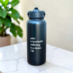 Personalised black stainless steel insulated water bottle with custom engraved motivational quote on marble surface