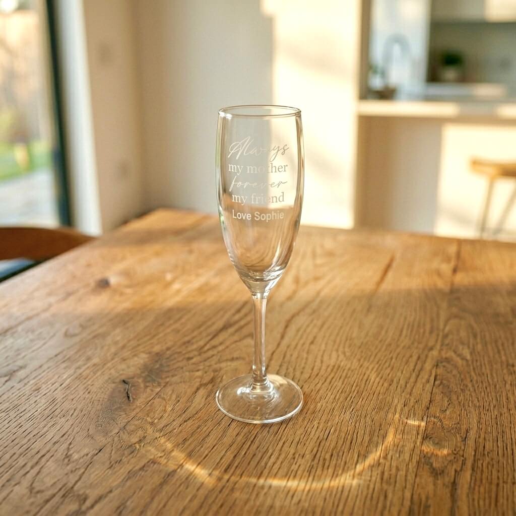 Personalised champagne flute gift for Mum with engraved sentimental message and custom name, shown on a sunlit wooden table