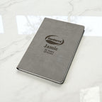 Personalised company logo journal on marble surface, engraved with name and years of service, an elegant business gift for NZ employees.