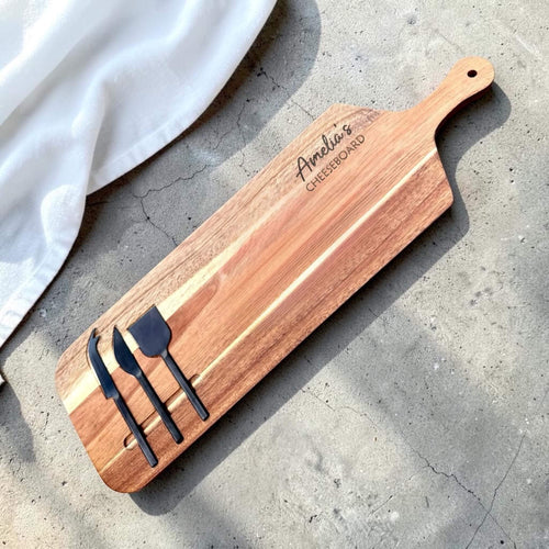 Personalised engraved acacia wood cheeseboard with custom name engraving and three black cheese knives in built-in slots, unique gift idea NZ