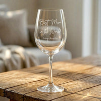 Personalised engraved wine glass for Mum with "Best Mum in the World, Love Amelia" script engraving, close-up on rustic wooden table