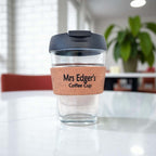 Personalised glass coffee cup with cork sleeve custom engraved “Mrs Edger’s Coffee Cup” on white marble table