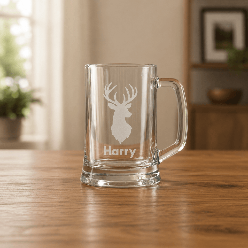 Personalised glass mug with deer head engraving and 'Harry' text on a wooden table.